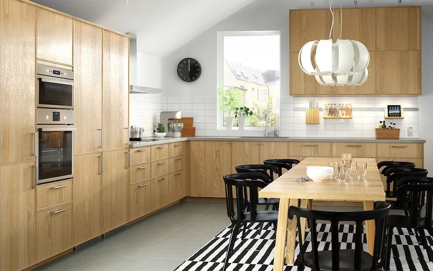 kitchen design, wooden laminated cabinets, dining area in the centre, striped rug, hanging light above the table