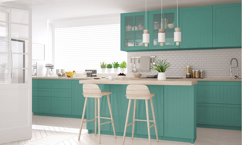 Teal blue and white kitchen withy chairs and other accessories.
