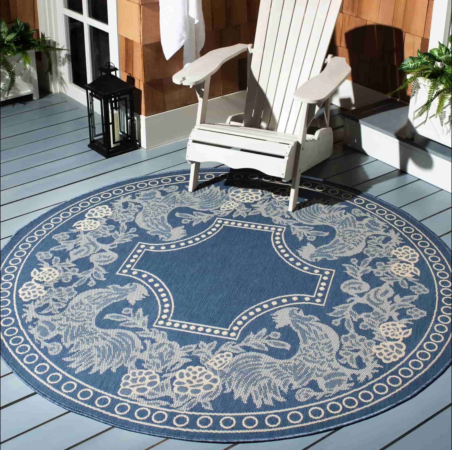 round rugs with royal prints, reclining chair placed on it, blue coloured carpet with prints, outdoor rugs for decks