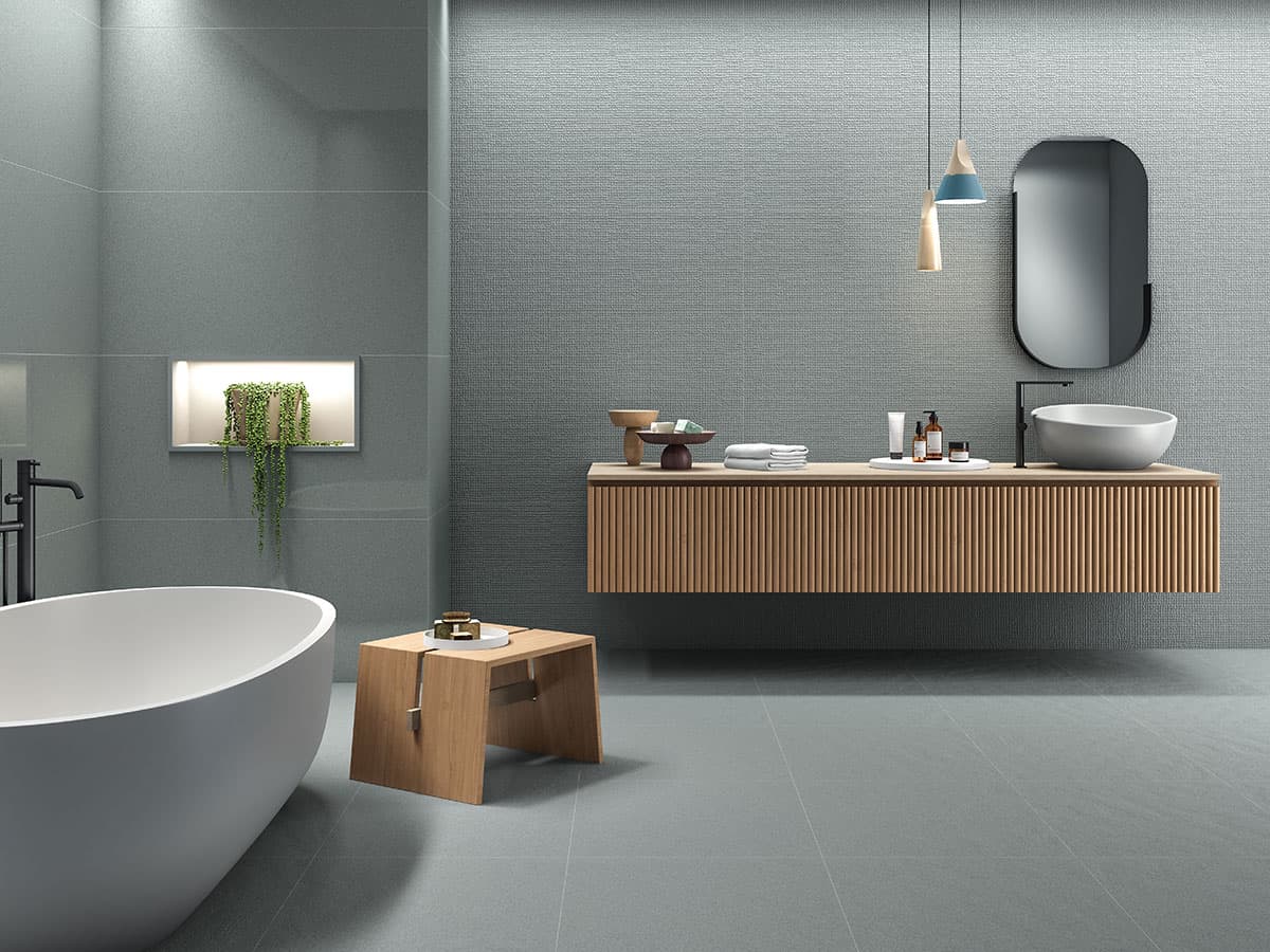 grey tile wall texture design in bathroom with a bathtub and vanity table