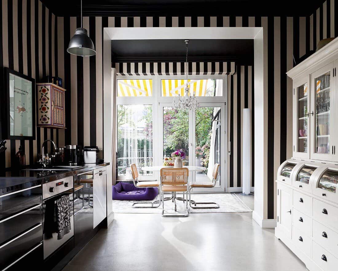 A kitchen wall designed with stripes and kitchen accessories.