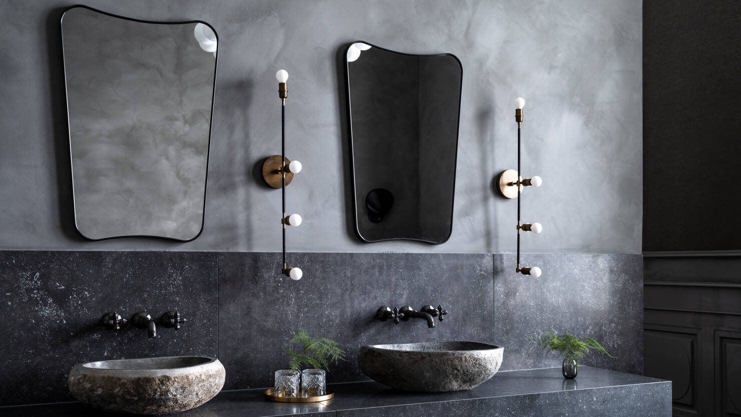 grey rugged bathroom with mirrors, washbasin and lighting fixtures