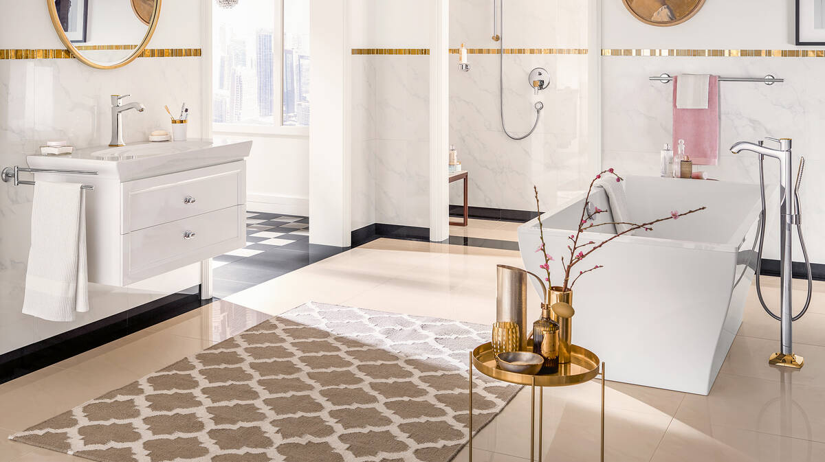 beige bathroom floors with a grey carpet with copper table, white bathtub, cabinets, washbasin, and s،wer