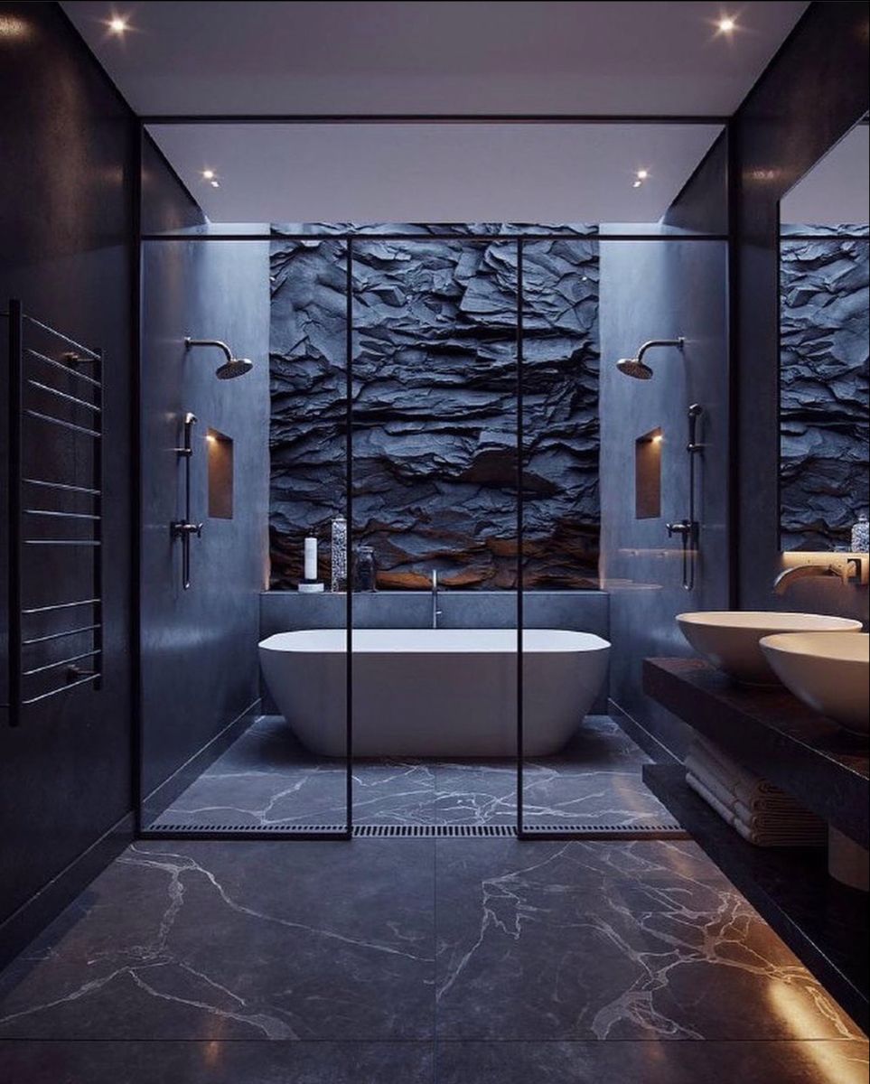 black bathroom with stone wall, bathtub, shower and washbasin