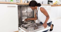 A girl using the dishwasher. how to clean the dishwasher with vinegar.