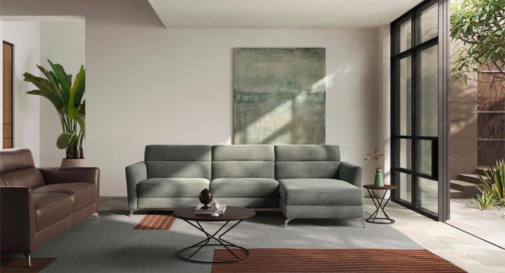 luxury couch with olive green colour, rug placed under the couch, a side table besides it, and a coffee table placed in the centre