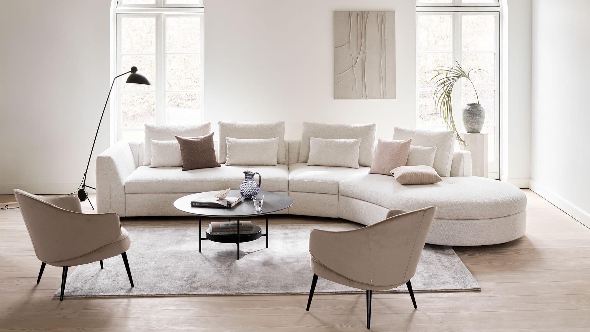 bergamo couch with round lounging is a trendy piece of furniture for your contemporary style minimal room, coffee table in the centre, rug under the furniture, chair