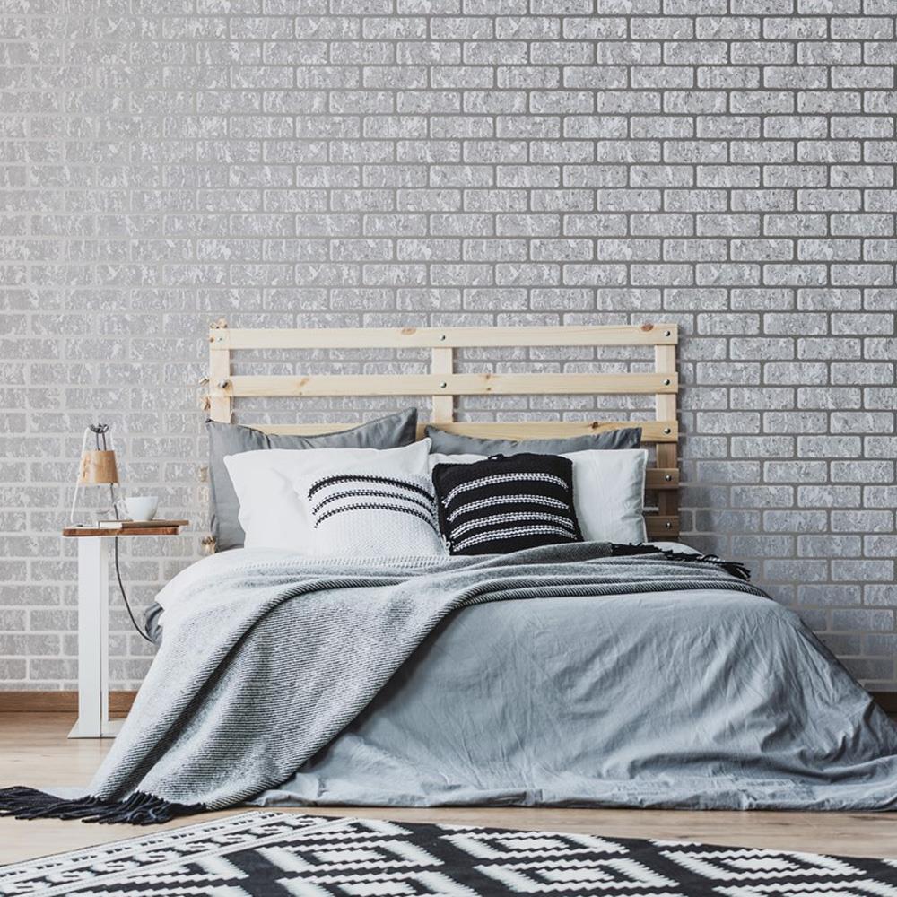 grey coloured brick wallpaper, bed, side table, rug, minimal decor