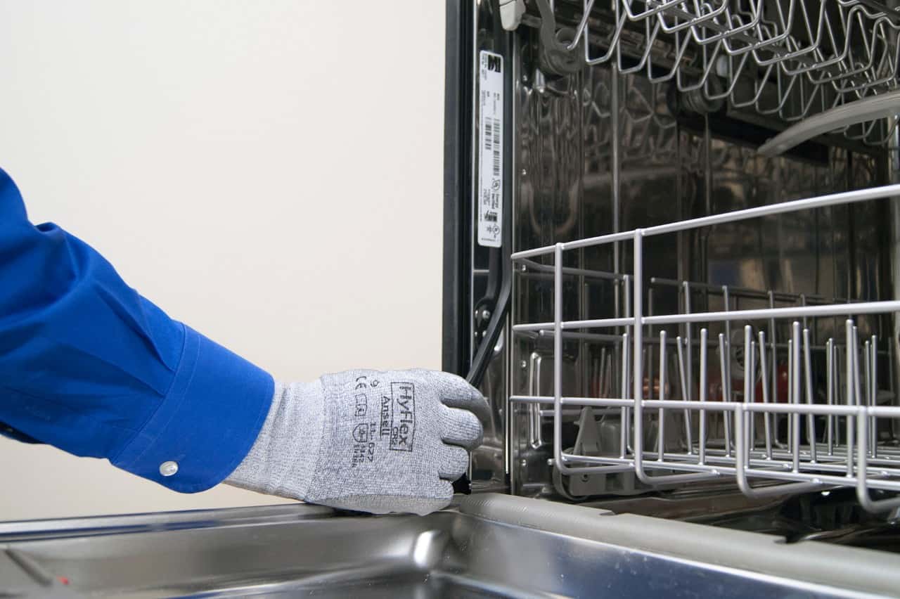 Cleaning the doors of a dishwasher machine.