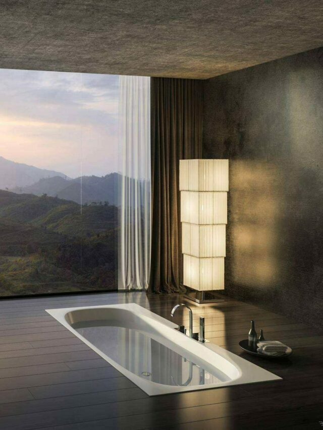 bathroom with bathtub black floors, washbasin and mountain view