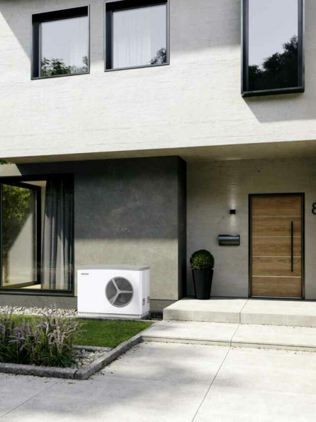 white heat pump installed indoors against a home facade