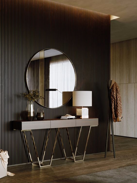 entryway console table design, faux gold sleek legs, with a lamp and indoor plant placed on it, and mirror hanged above