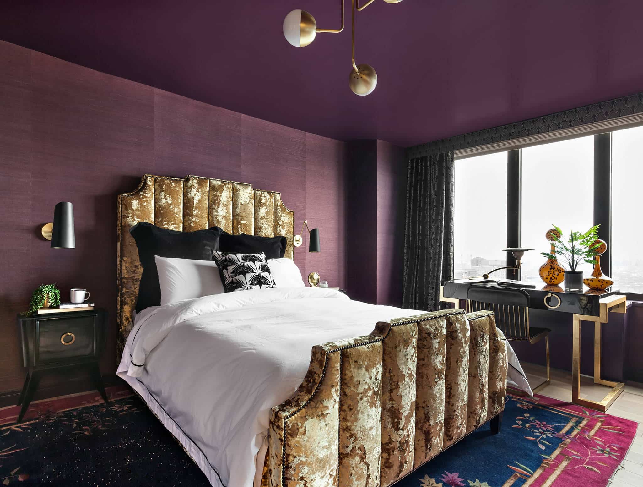 beautiful design intricate on bed, purple walls, hanging lights, with gold, two-colour combination