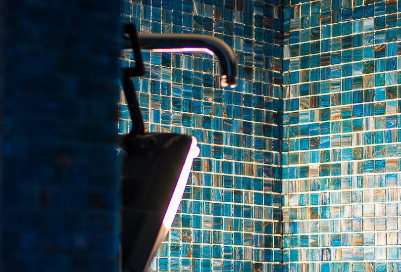 Bright washroom tiles with a tap