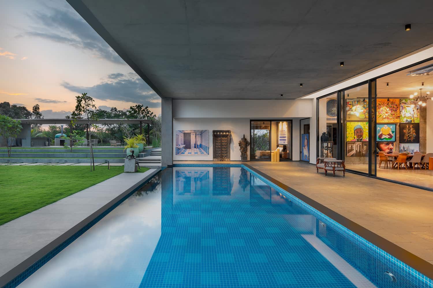 modern luxury home designed by Keystone architects in bangalore, home interior design with an open plan living room leading to an expansive swimming pool and outdoor garden
