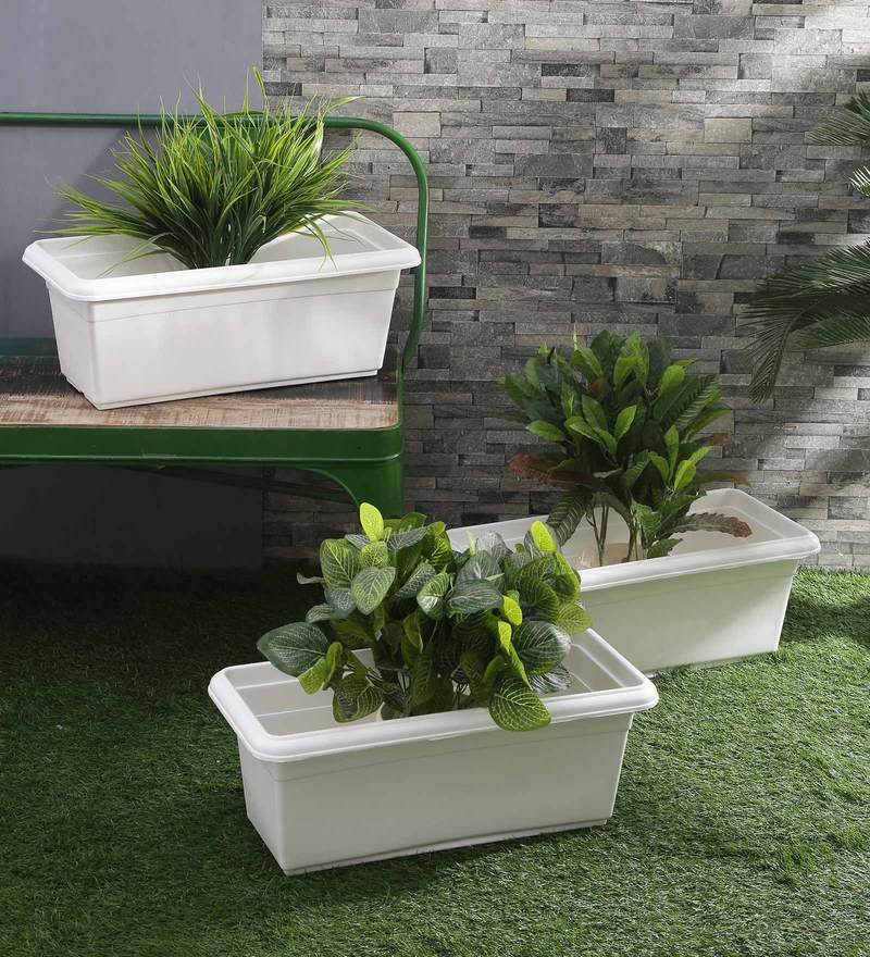 white plastic planters with plants.