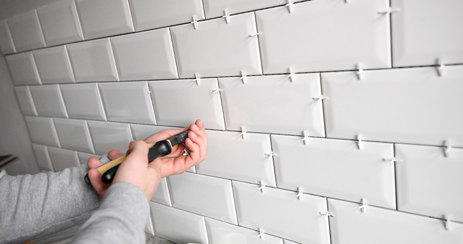 Tile spacers being used before grouting on tile design.