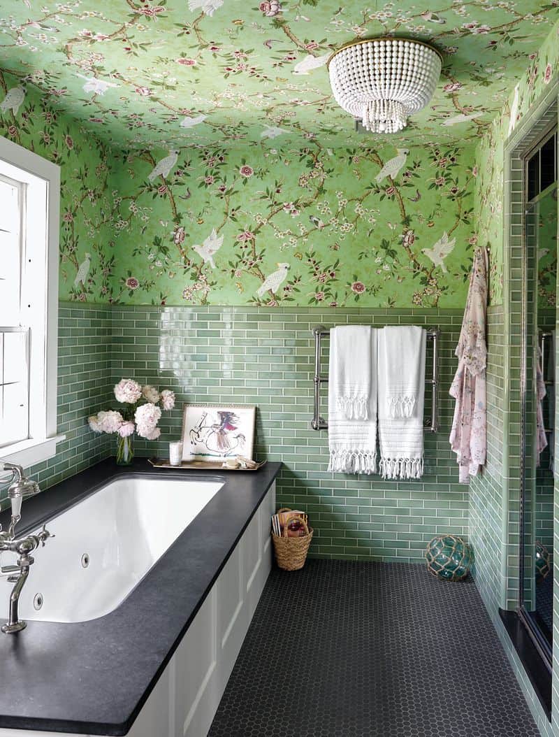 A bright green washroom setup with a tub.