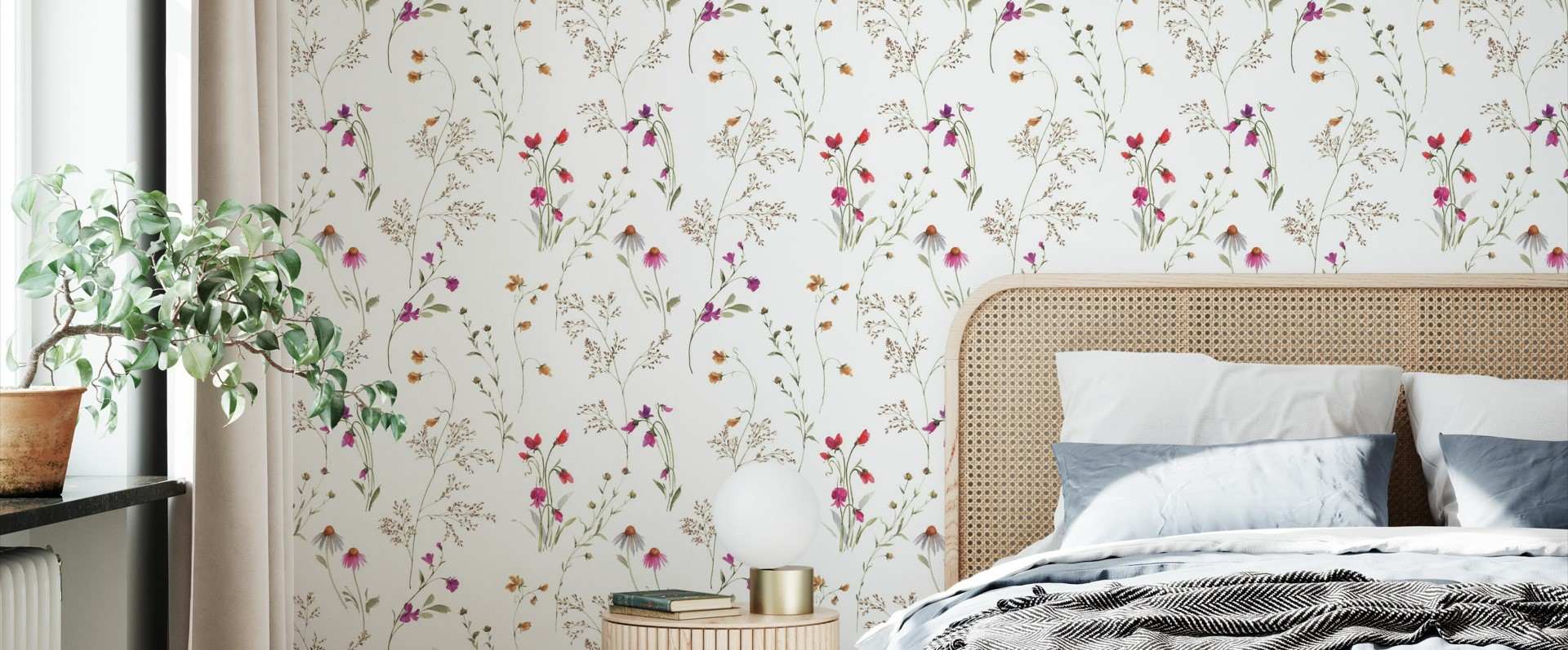 White floral wallpaper in a bedroom with a bed and a plant