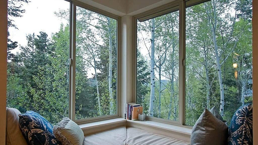 A home with corner window in the forest