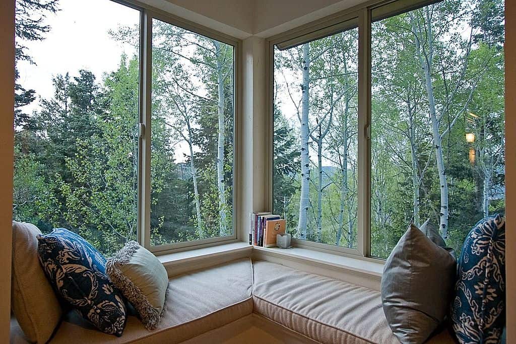 A home with corner window in the forest