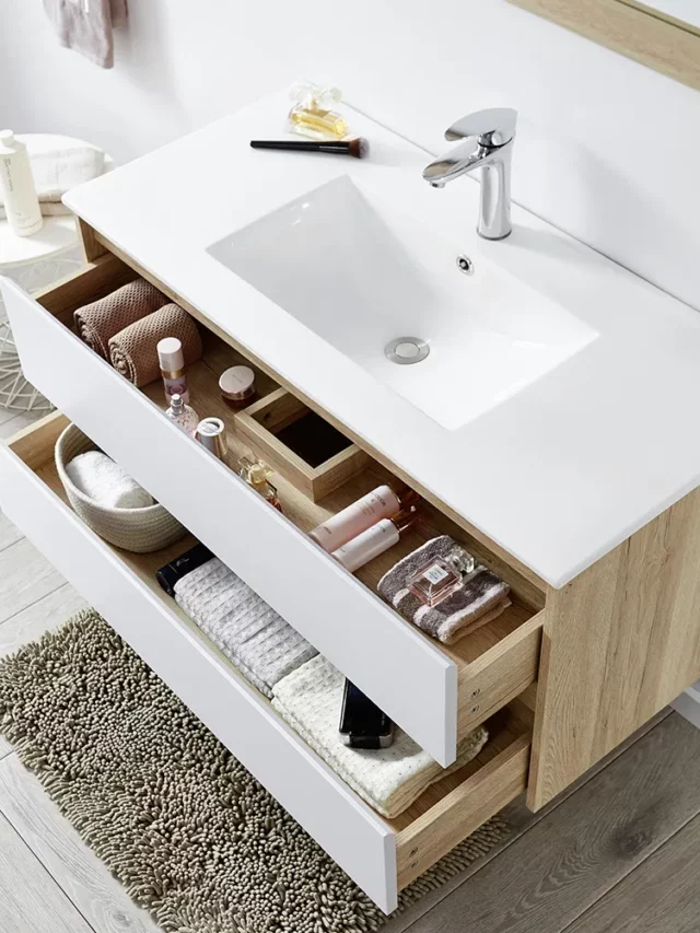 white bathroom vanity in a bathroom with drawers open