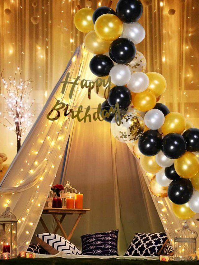 white black and golden balloons in a room with tent and lights