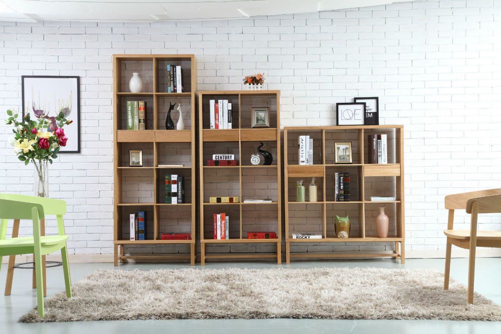 Multi-storied stand alone wooden showcase for living room backed by a white bricked wall