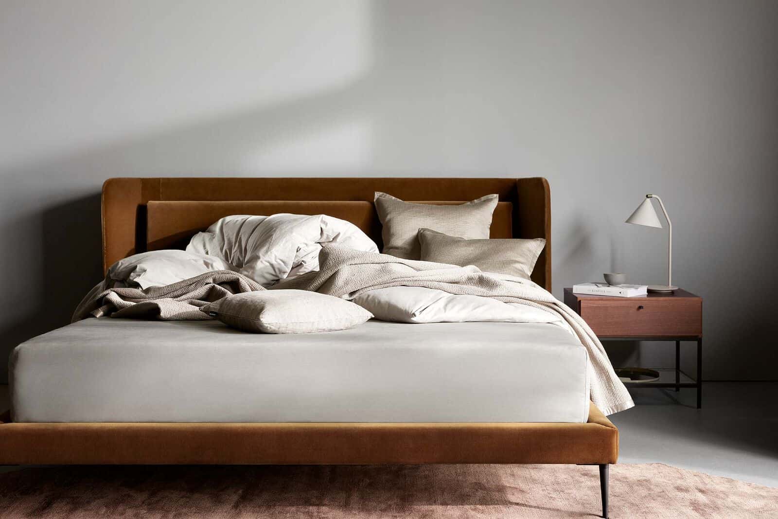 white bedroom with a modern wood double bed design and a brown rug