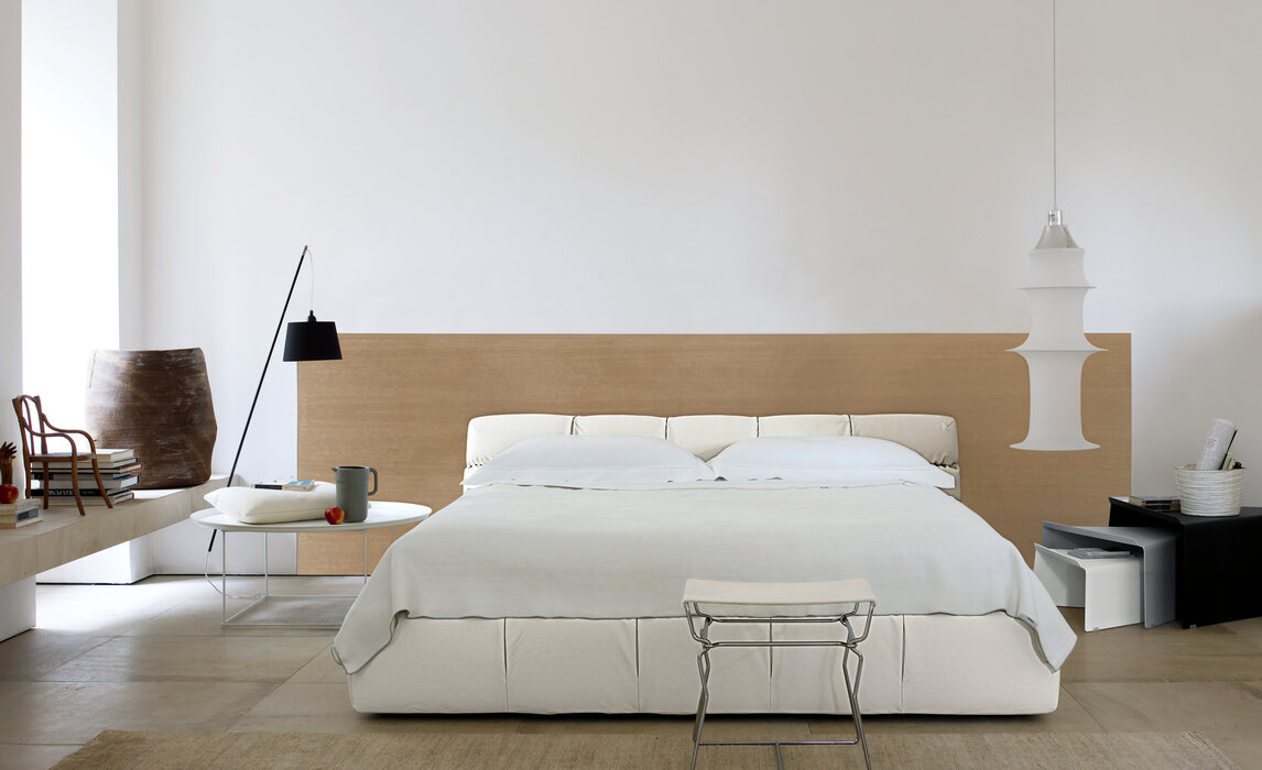 white bedroom bed, table, pendant light, with a rug