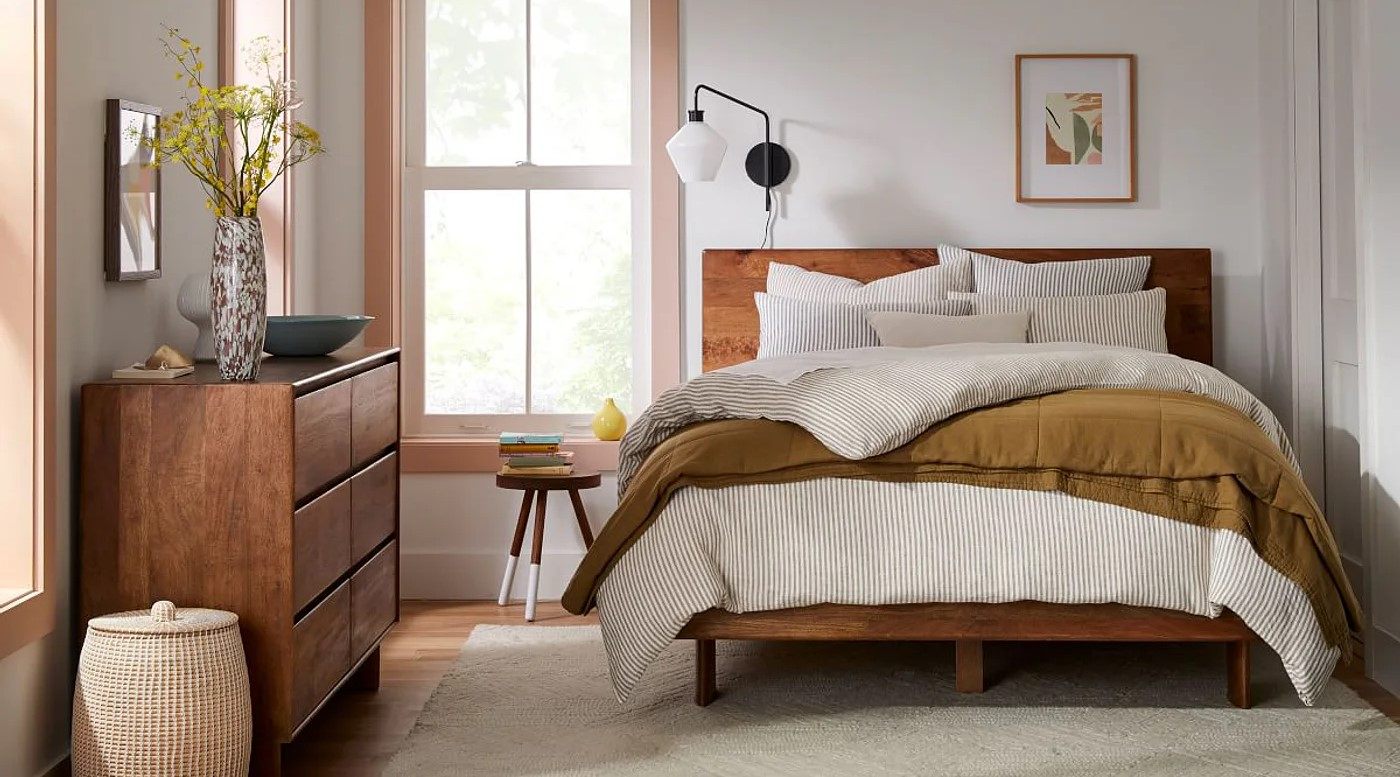  brown cabinet, white rug and wall lamp