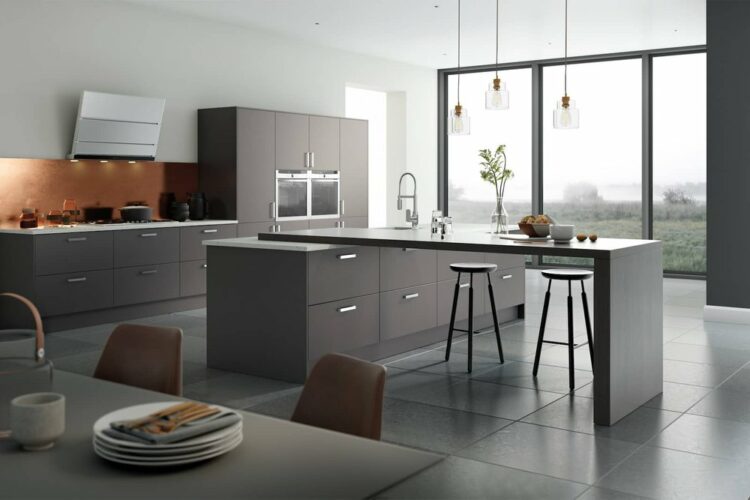 grey cooking space with dark grey cabinets, pendant lights, kitchen island and chimney