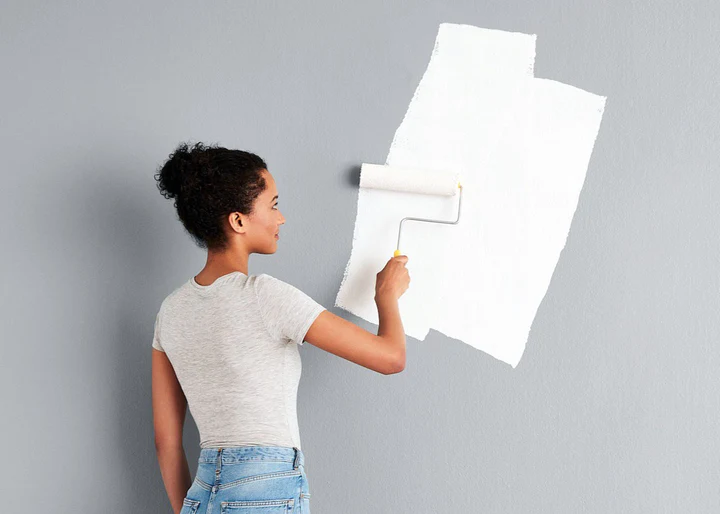 Applying the base coat on the wall before painting