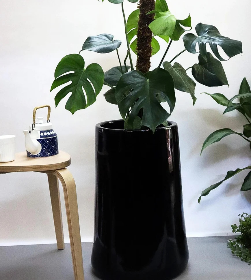 Large planter in black colour with kettle and chair