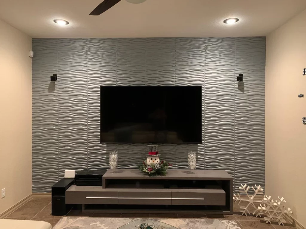 Grey 3D wall panel with a tv mounted on it