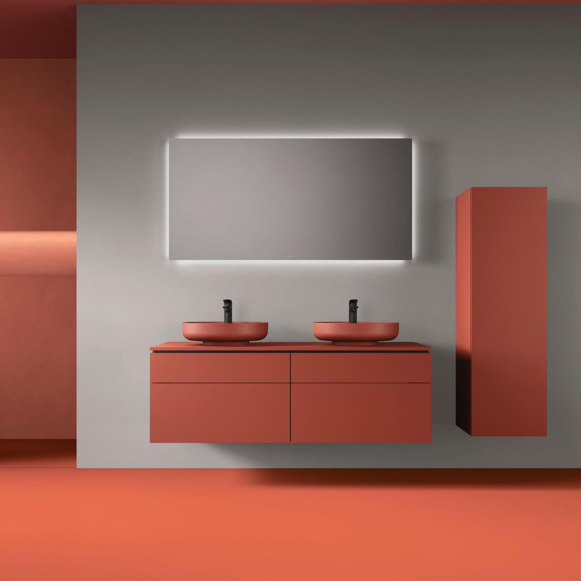 coloured sanitary ware in orange washbasin and cabinets in a bathroom with mirror
