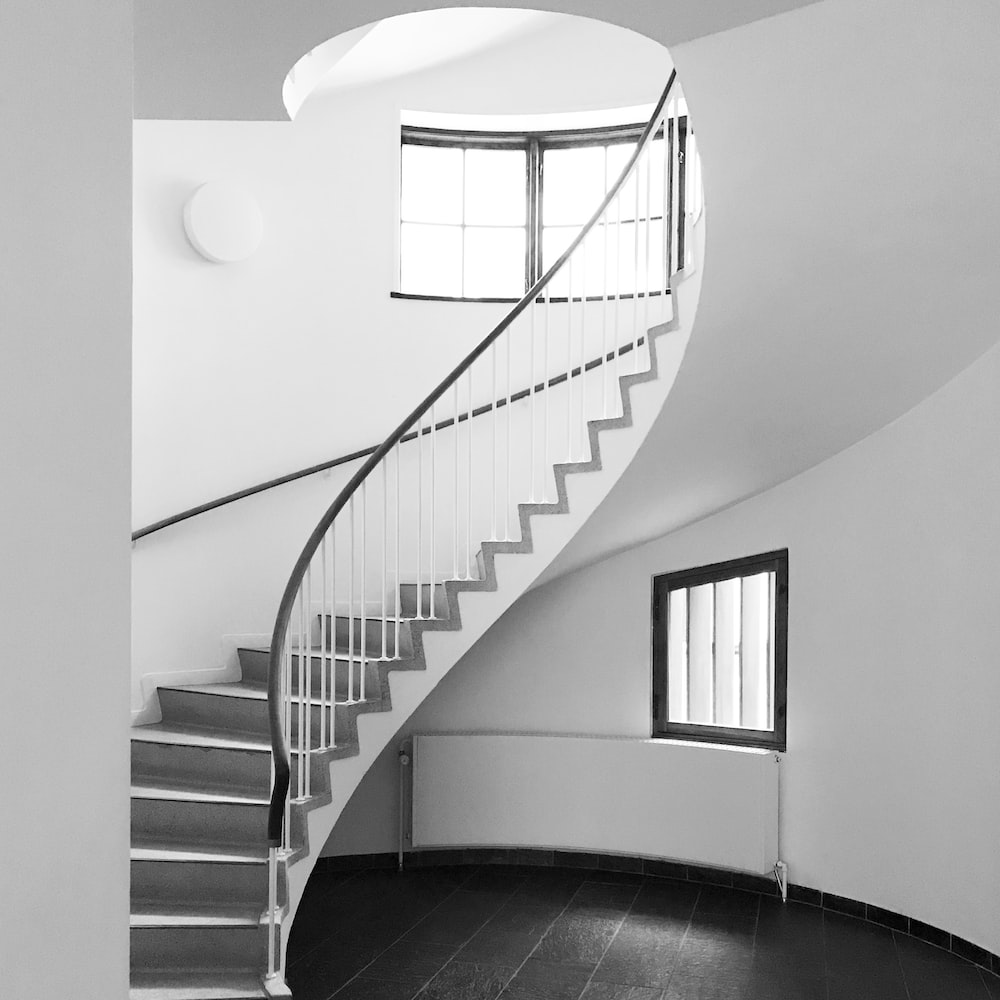 Minimal and monochromatic staircase design, all-white, right direction, vastu-approved