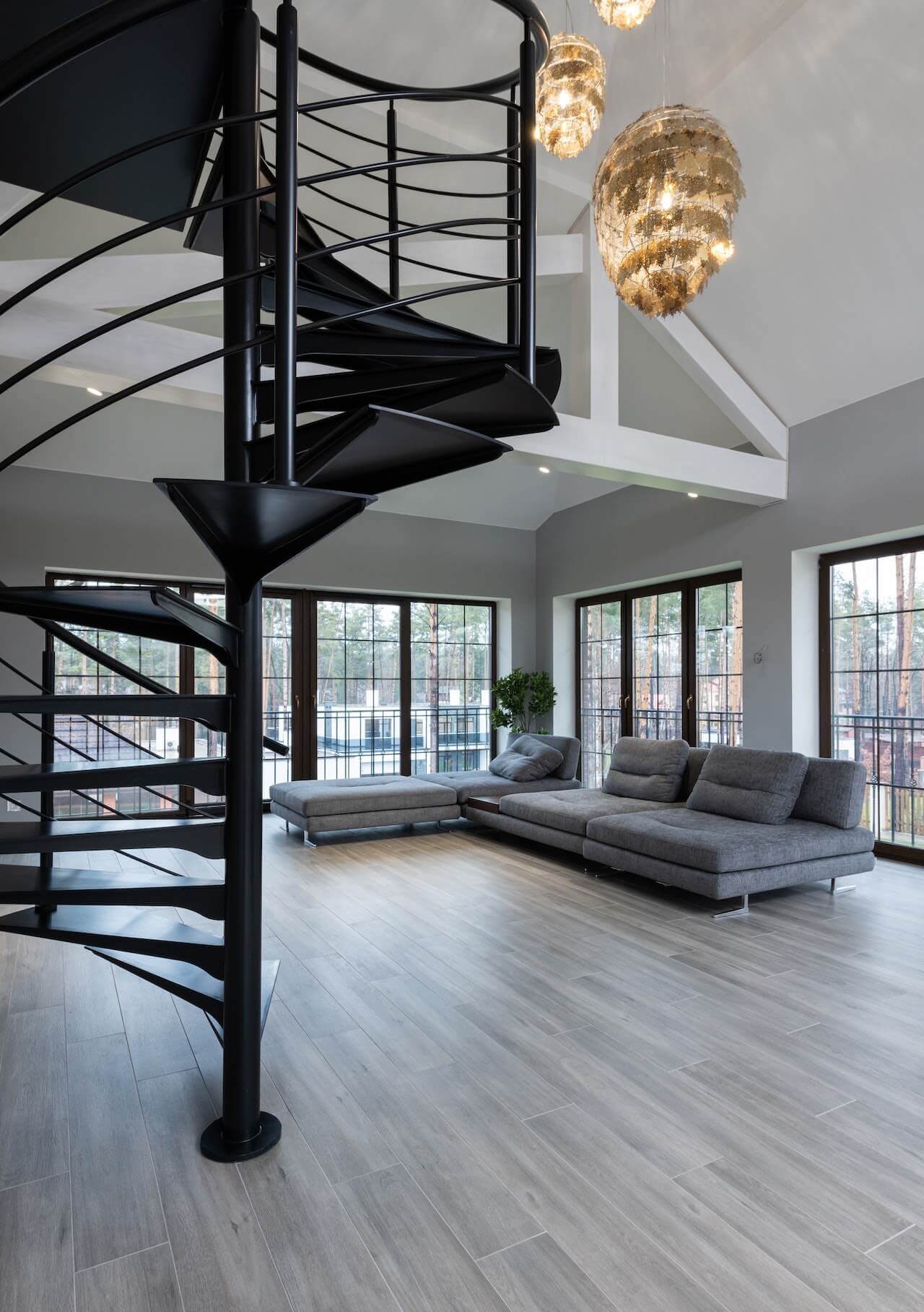 metal stairs leading upwards, black painted metal stairs, spiral shaped in living area, small space stair ideas