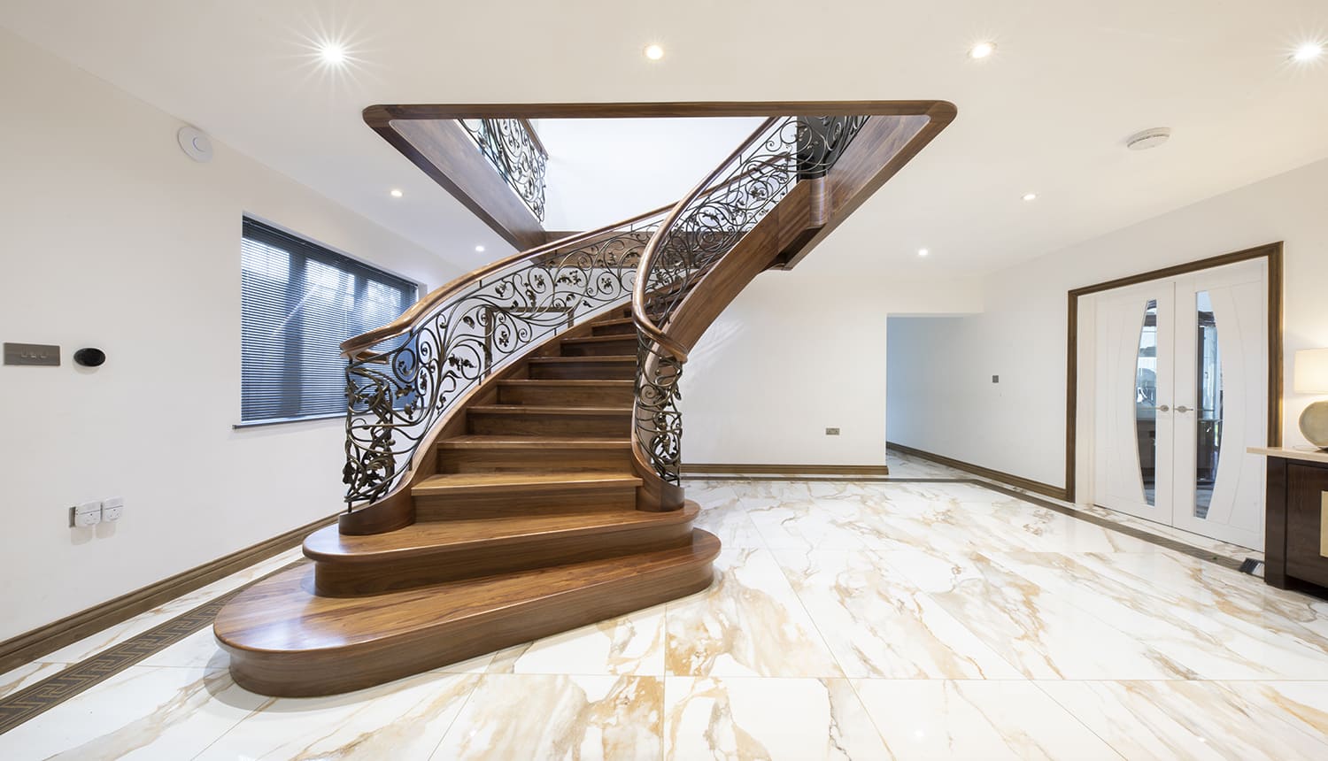 curved wooden staircase with elegant railing gracefully ascending, small space staircase design