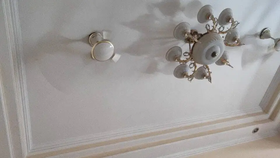 False ceiling with 2 fans and a chandelier