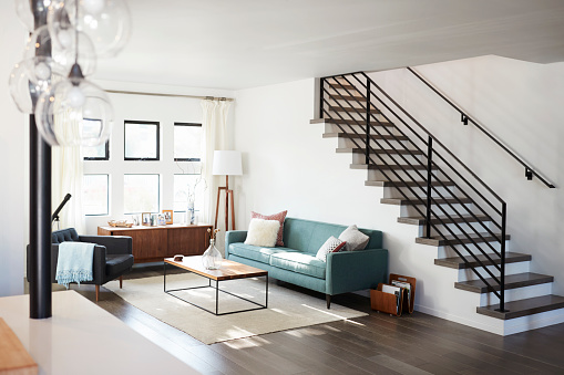 modern interior design, stairs, sofa, wooden flooring, coffee table, rug