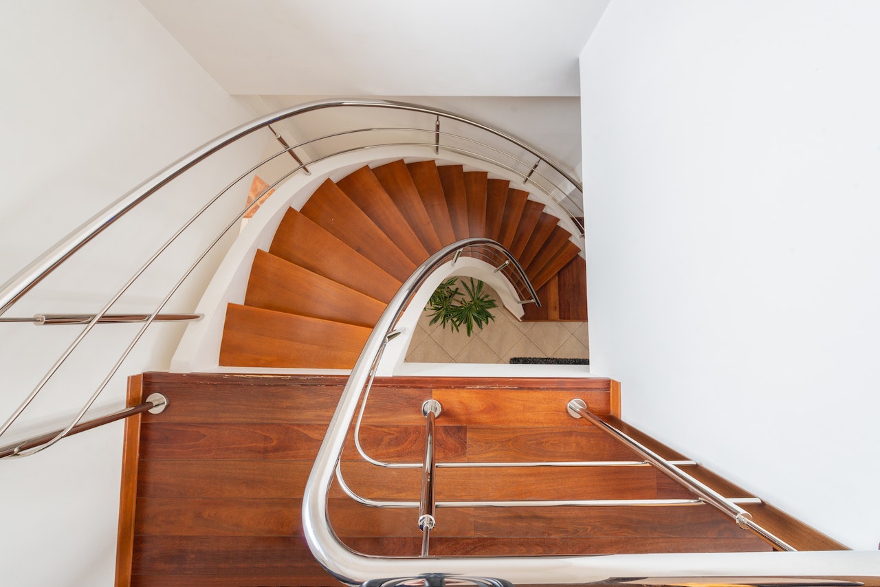 A graceful curved staircase with sturdy railing, guiding the way to the upper levels