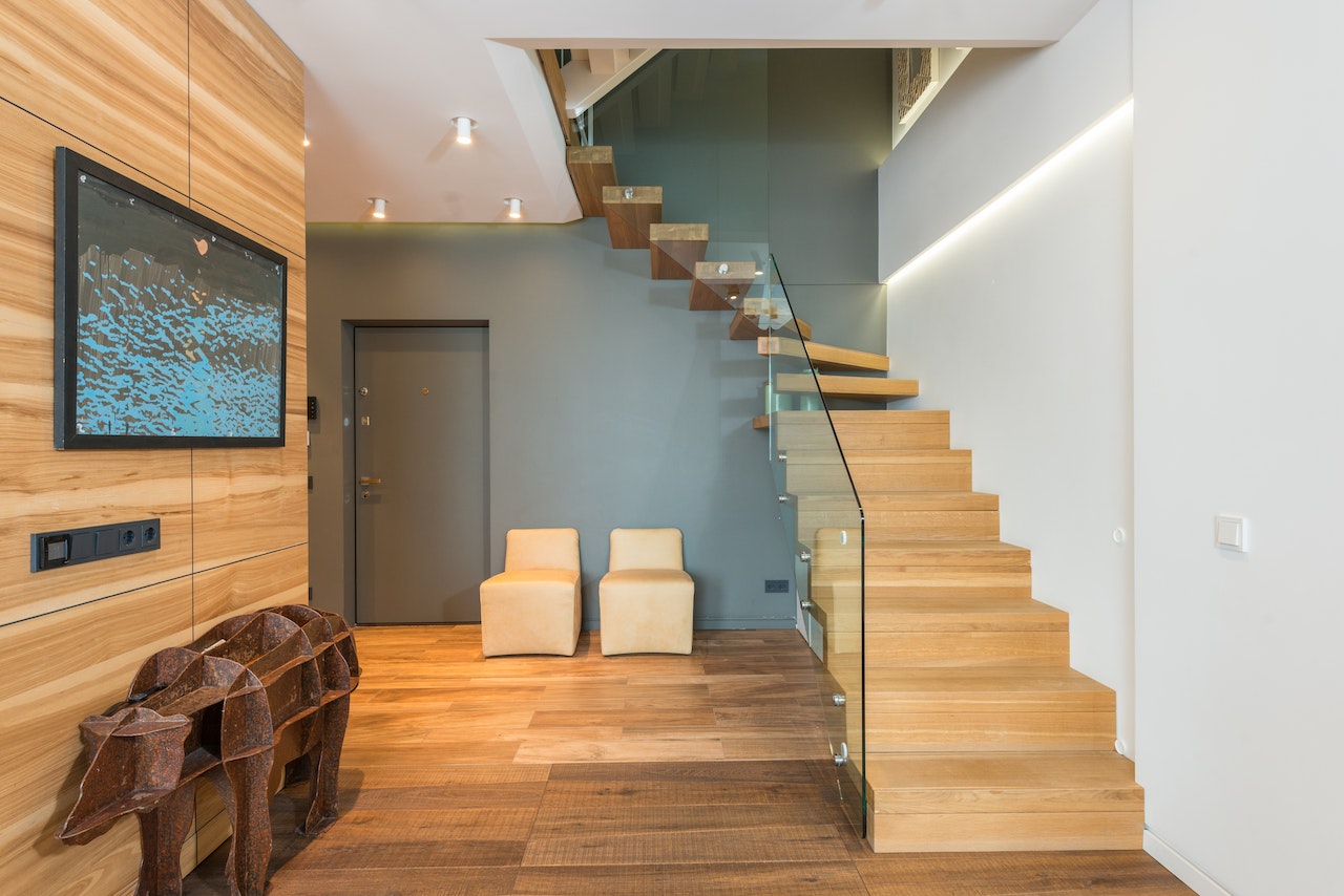 glass staircase railing with wooden steps for living area, contemporary home design