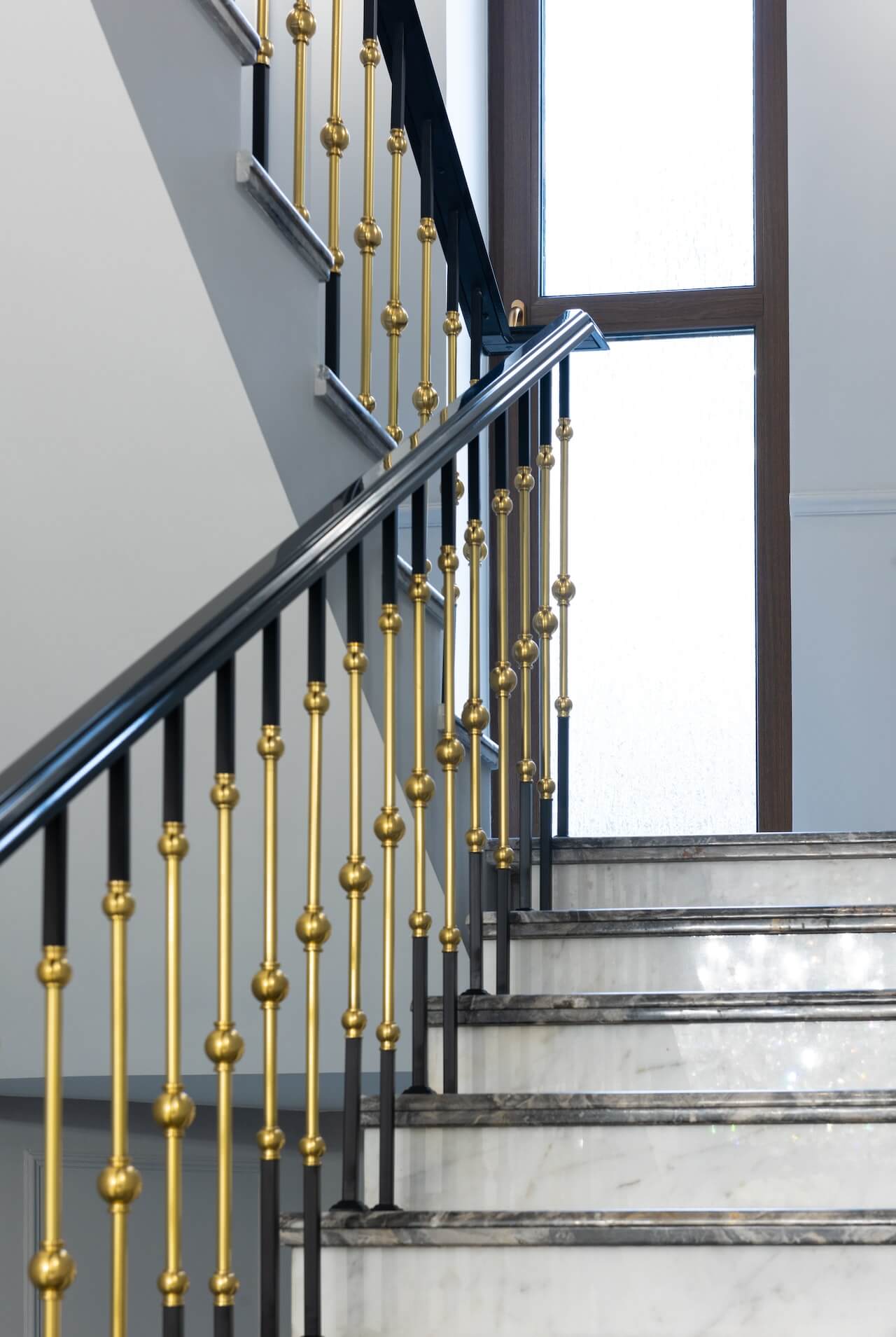 An elegant ornate railing staircase with intricate ironwork, showcasing a timeless and grand design