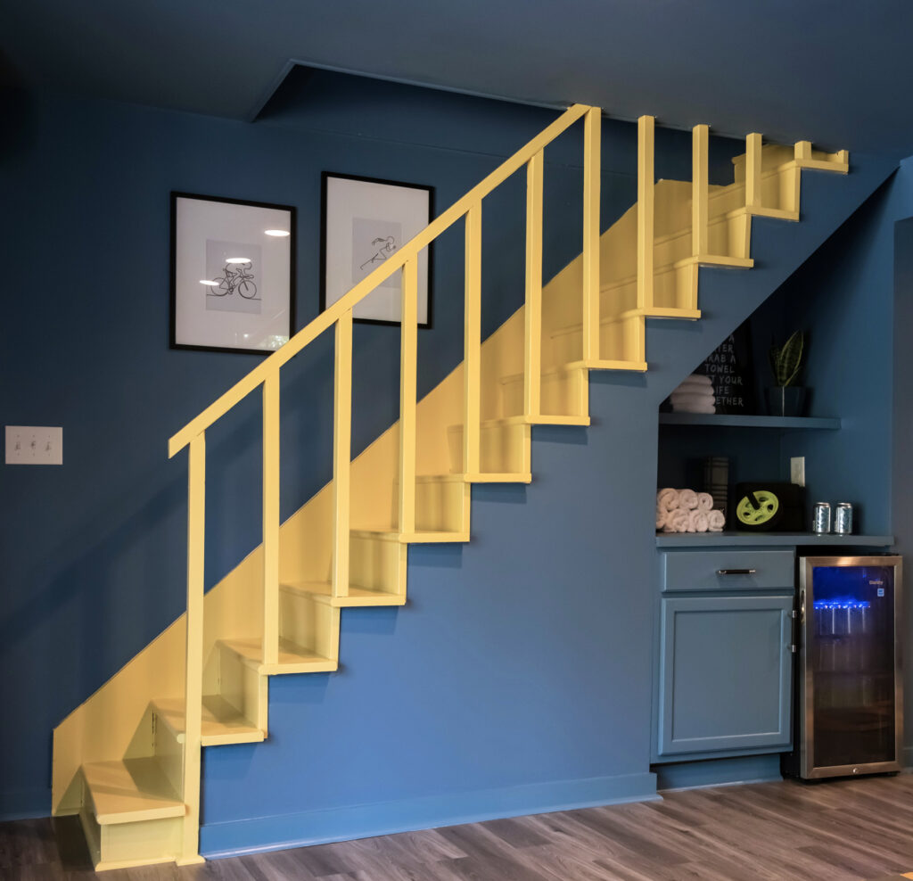 Yellow painted stair railing design with blue background