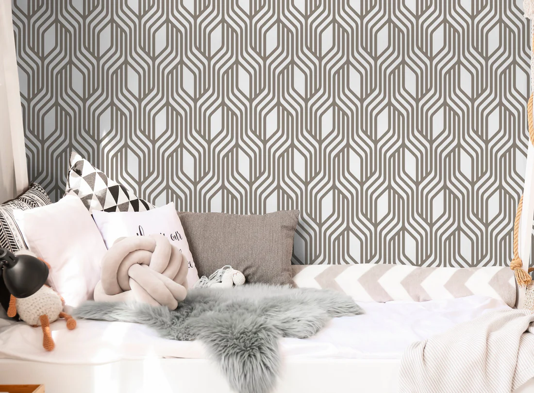 black and white wallpaper in a room with bed, pillows and blanket