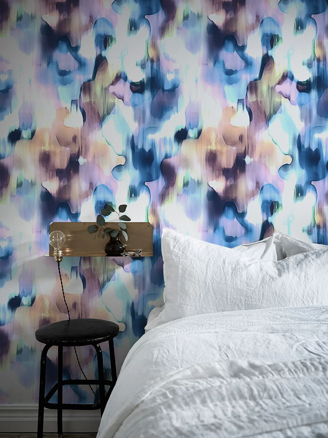 blue wallpaper in a bed room with a bed and side table