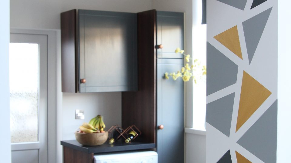 Kitchen wall with geometric design and cabinets