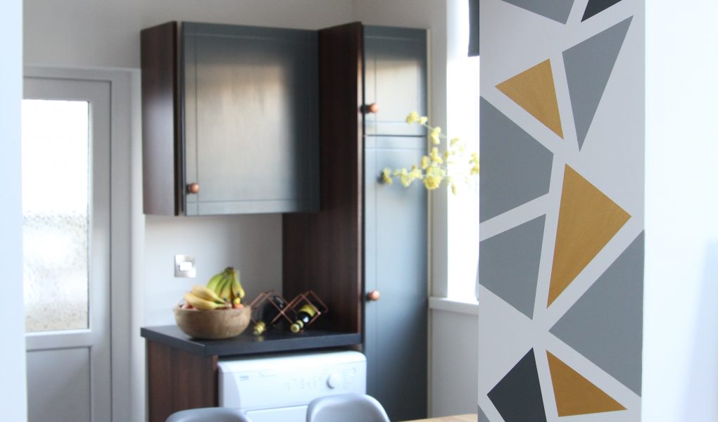 Kitchen wall with geometric design and cabinets