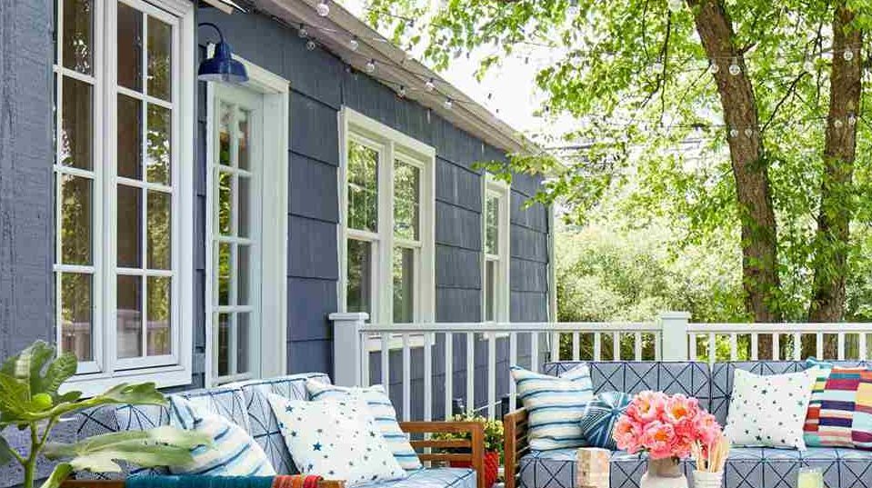 Grey outdoor seating with plants and chairs